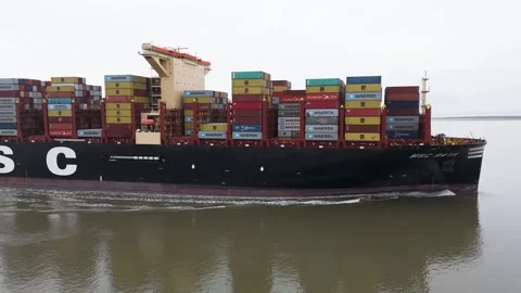 Profile msc container ship raya moving smoothly through dutch waterway black Stock Footage 328198899