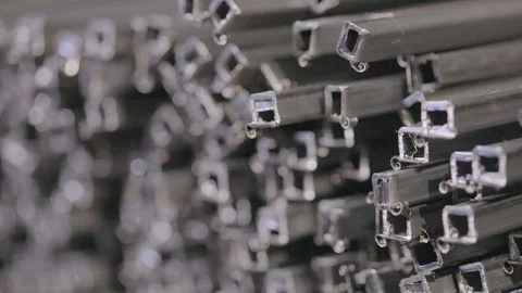 Profile pipe in a covered warehouse, profile pipe laid in rows in a large Stock Footage 94940437