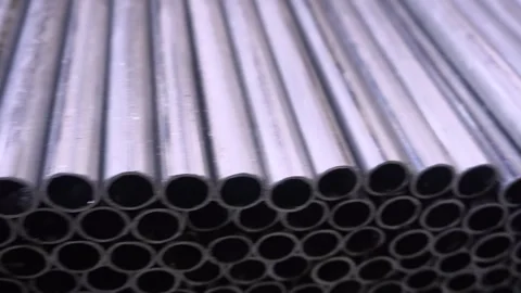 Profile pipe in a covered warehouse, profile pipe laid in rows in a large Stock Footage 320335369
