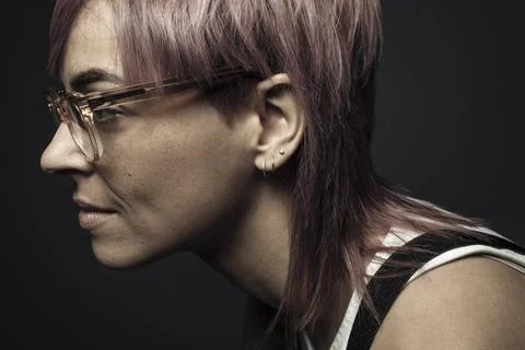 Profile portrait beautiful non-binary gender person with pink hair and eyeglasse Stock Photos