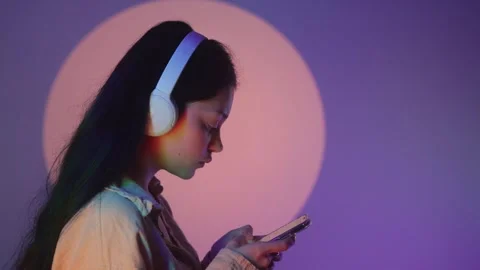 Profile portrait of charming dark-haired woman in massive headphones listening Stock Footage 271196429