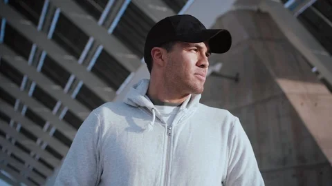 Profile portrait of handsome Hispanic man looking serious around modern urban Stock Footage 105755530