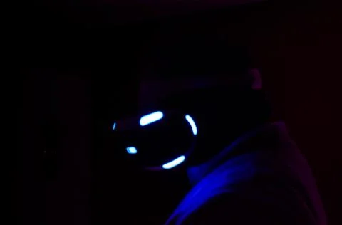  profile portrait of a man using the virtual reality glasses on a dark backgroun Stock Photos