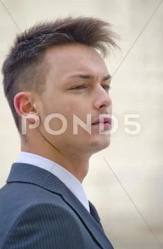 Profile portrait of young businessman in suit Stock Photos