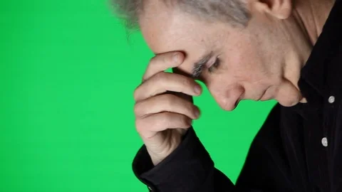 Profile of Senior Man Bowing Head on Green Screen Stock Footage 104777657