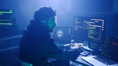Profile of serious hacker printing a code to break into a secret internal Stock Footage 108820346