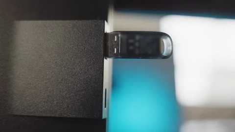 Profile shot close up hand inserts memory stick flash drive into computer at Stock Footage 337012632
