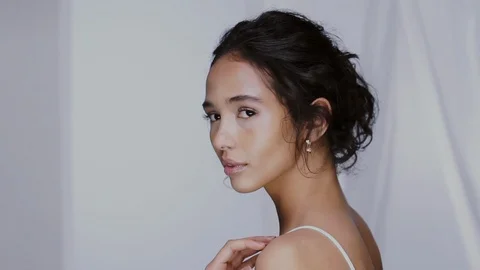 Profile shot of elegant girl smiling and touching her shoulder Stock Footage 123729241
