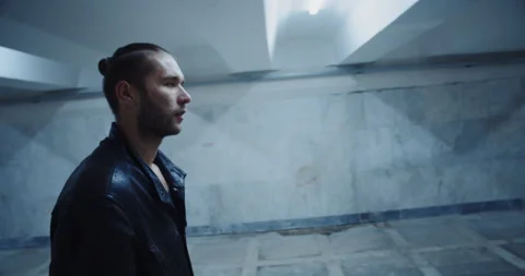 Profile shot exhausted guy or addicted junk bad looking young man walking in the Stock Footage 170462275