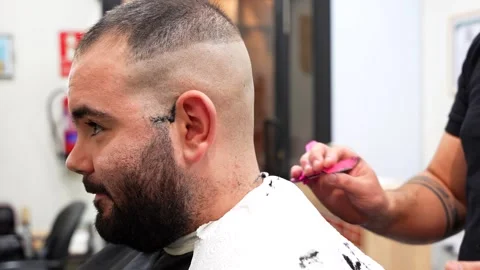 Profile shot of smiling client being shaved by barber Stock Footage 320393420