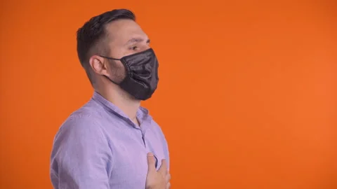 Profile shot of young man taking off face mask and breathing freely. Smiling at Stock Footage 138497385