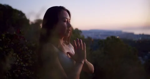 Profile side shot of mixed race calm woman holding palms together at mountain Stock Footage 120945451