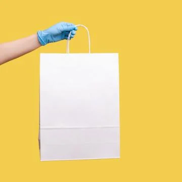 Profile side view closeup of human hand in blue surgical gloves holding and s Foto stock