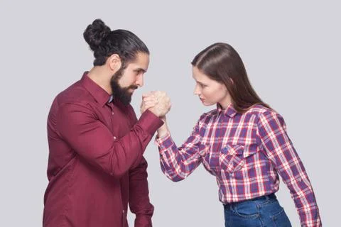 Profile side view portrait of bearded man and woman in casual style standing  Foto stock