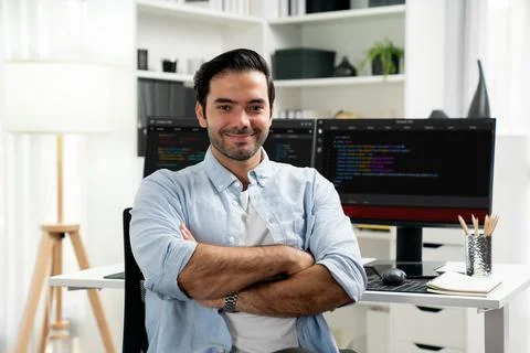Profile smart IT developer looking camera against on coding pc screen. Surmise. Stock Photos
