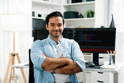 Profile smart IT developer looking camera against on coding pc screen. Surmise. 写真素材