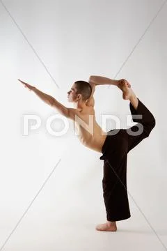 Profile of sporty guy doing physical exercise over grey background Stock Photos
