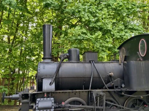 Profile of steam engine with natural background. Side view of steam engine .. Stock Photos