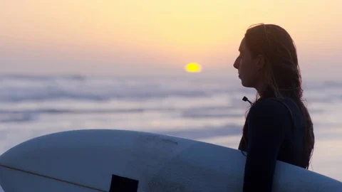 Profile Of Surfer Watching The Waves At Sunset, Peaceful Moment Stock Footage 92977851