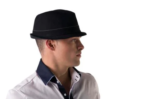 Profile view of attractive young man with fedora and white shirt Stock Photos