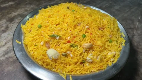 Profile view of Basanti pulao with nuts and raisins. Stock Footage 296728793