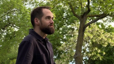 Profile View of Bearded Man Walking in Subotica Park Видео 336178362