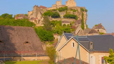 Profile view of Beynac Caste on top of hill with greenery in France. Village Stock Footage 318205146