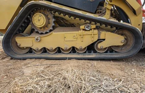 Profile view of crawler track system, rollers, and drive sprocket on indust.. Stock Photos