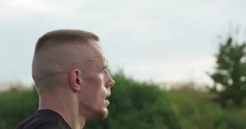 Profile view of kickboxer doing fast jumps on skipping rope on nature Vídeo Stock 133531493