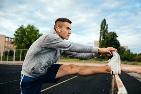 Profile view of a man doing exercises Stock Photos