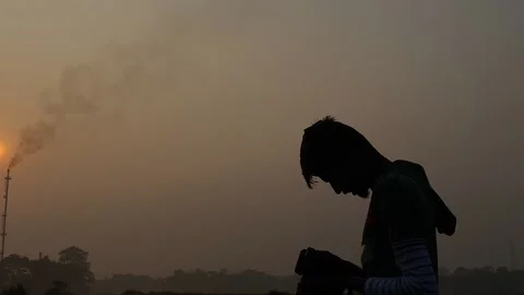 Profile view of photographer with camera capturing environment near Gas 스톡 동영상 231458232