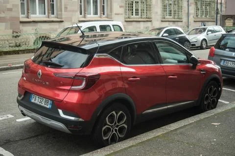 Profile view of red Renault Captur parked in the street Stock Photos