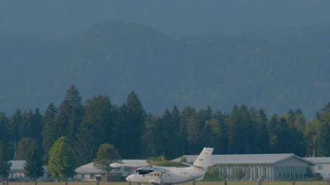 Profile view of small passenger airplane landing at Ljubljana airport, Slovenia Stock Footage 157083548