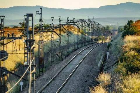Profile view of train line towards mountains Stock Photos
