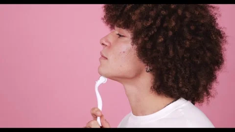 A profile view of a young boy using a white facial cleanser on his cheek against Stock Footage 269136829