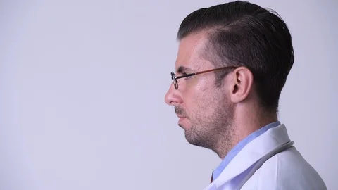 Profile view of young happy Hispanic man doctor smiling Stock Footage 97201837