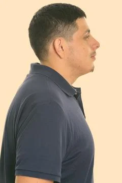 Profile view of young Hispanic man studio shot Stock Photos