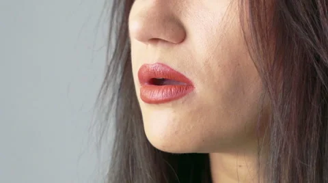 Profile of woman face blowing fume on beige background. Slowly Stock Footage