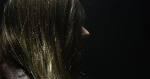 Profile of a woman's face in a warehouse Stock Footage 97519864