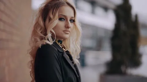 The profile of a young blonde, with voluminous curls, long hair, typographic Stock Footage 157557663