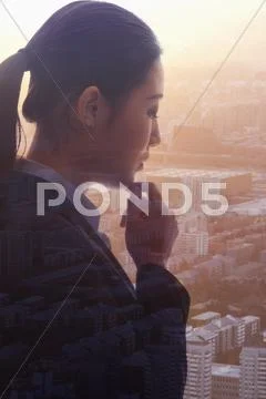 Profile of young businesswoman contemplating, double exposure of cityscape, Stock Photos