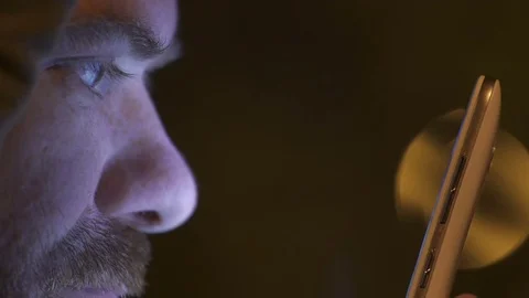 Profile of young man concentrating on using the smartphone at night Video stock 74701721