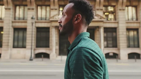 Profile of young man walking down the st... | Stock Video | Pond5