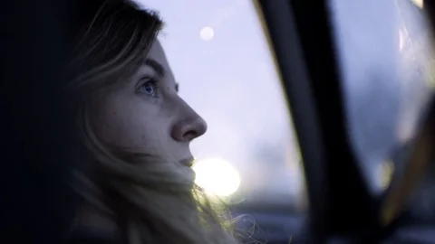 Profile Of Young Woman's Face As She Looks Out The Car Window At Night Stock Footage 71998077