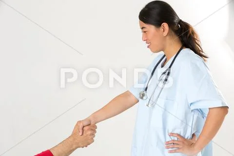 Profiled Asian Nurse Shaking Patient's Hand