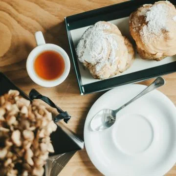 Profiterole or eclair. Profiterole with custard cream filling served for Stock Photos