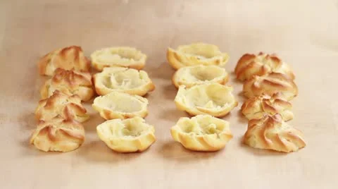 Profiteroles being filled with cream Stock Footage 24652679