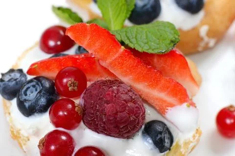 Profiteroles with berries currant Stock Photos