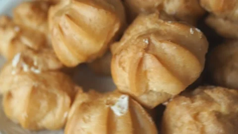 Profiteroles with custard cakes rotate Video stock 132162287