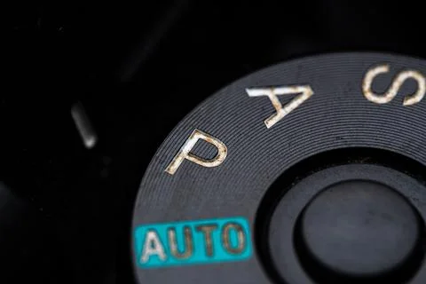 The program adjustment dial is close on the camera. Old and dirty Stock Photos